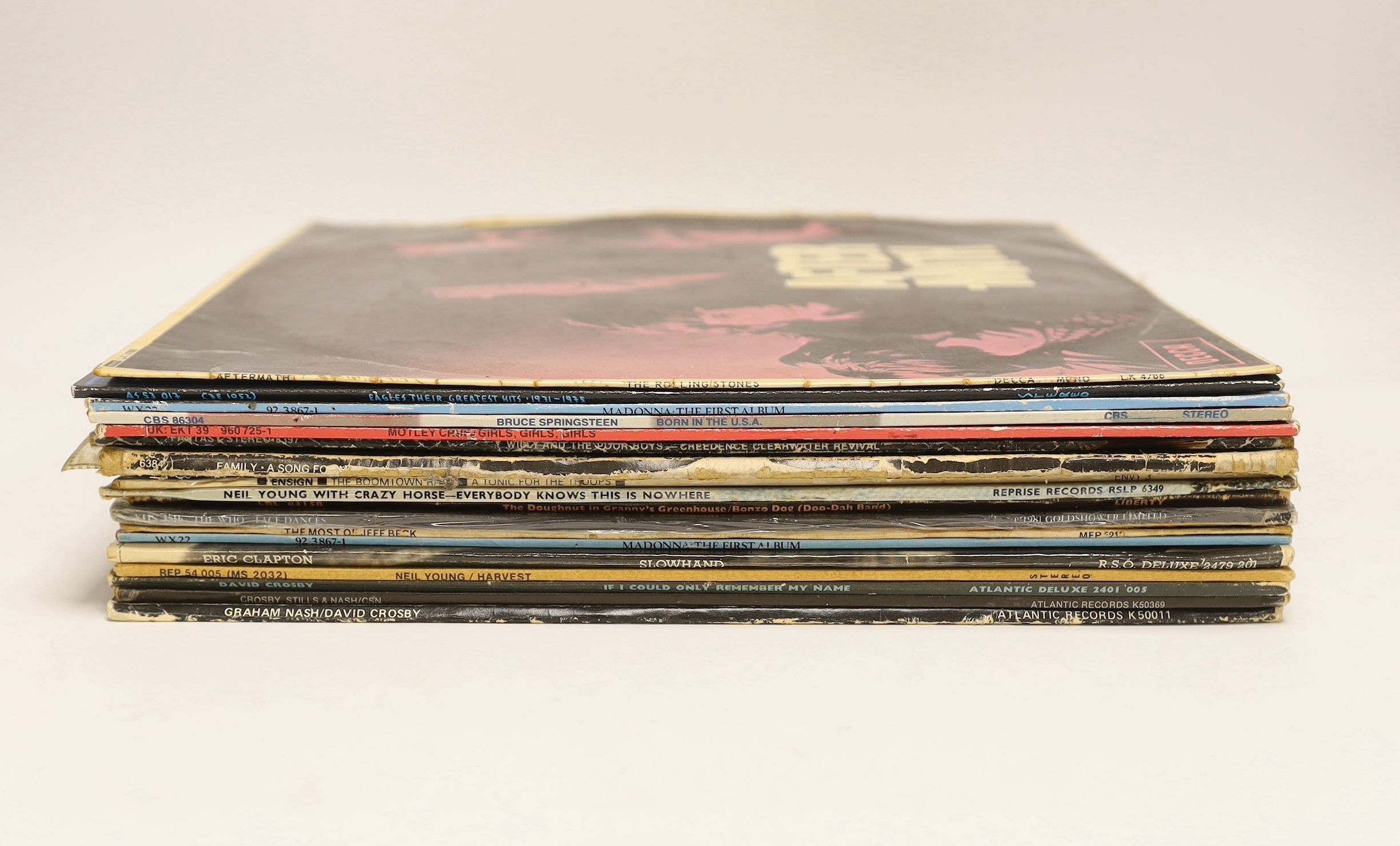 Eighteen LP record albums, artists including; The Rolling Stones, the Eagles, Madonna, Bruce Springsteen, Mötley Crüe, Jeff Beck, Eric Clapton, etc.